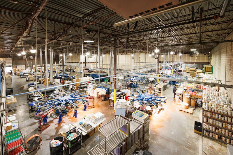 Large warehouse interior with various equipment and materials.